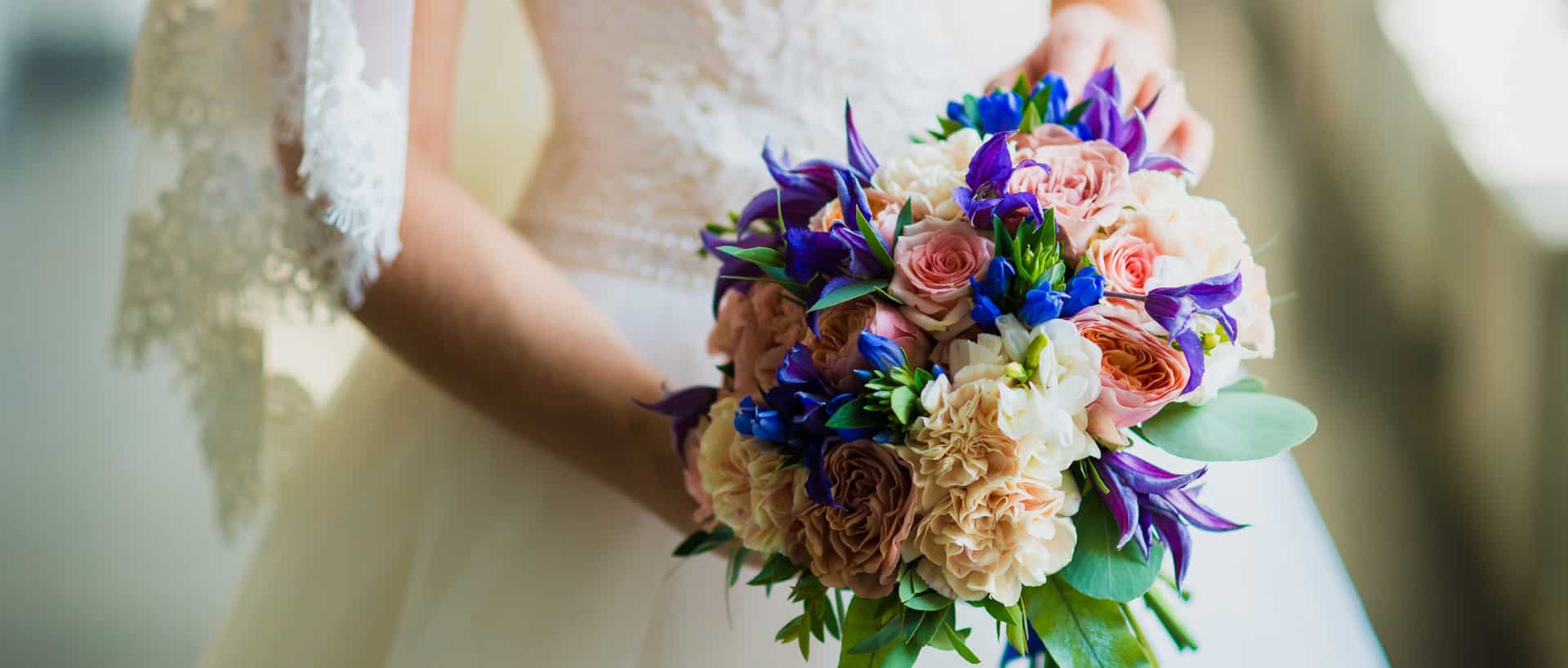 Bride holding lilac and soft pink bouquet