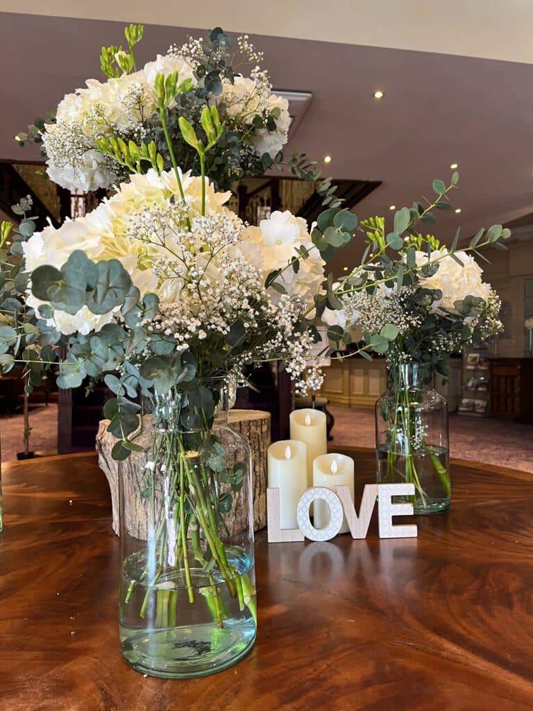 A beautiful bunch of flowers with a Love sign in the reception area of the Woodford Dolmen Hotel on your wedding day