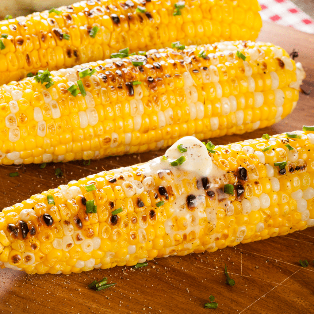 Three pieces of corn on the cob with melted chilli lime butter on top.