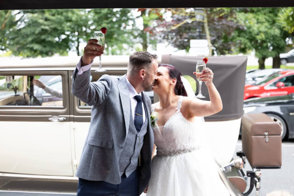 Amy & Kevin Toasting with Prosecco in front of the Woodford Dolmen Hotel, Carlow