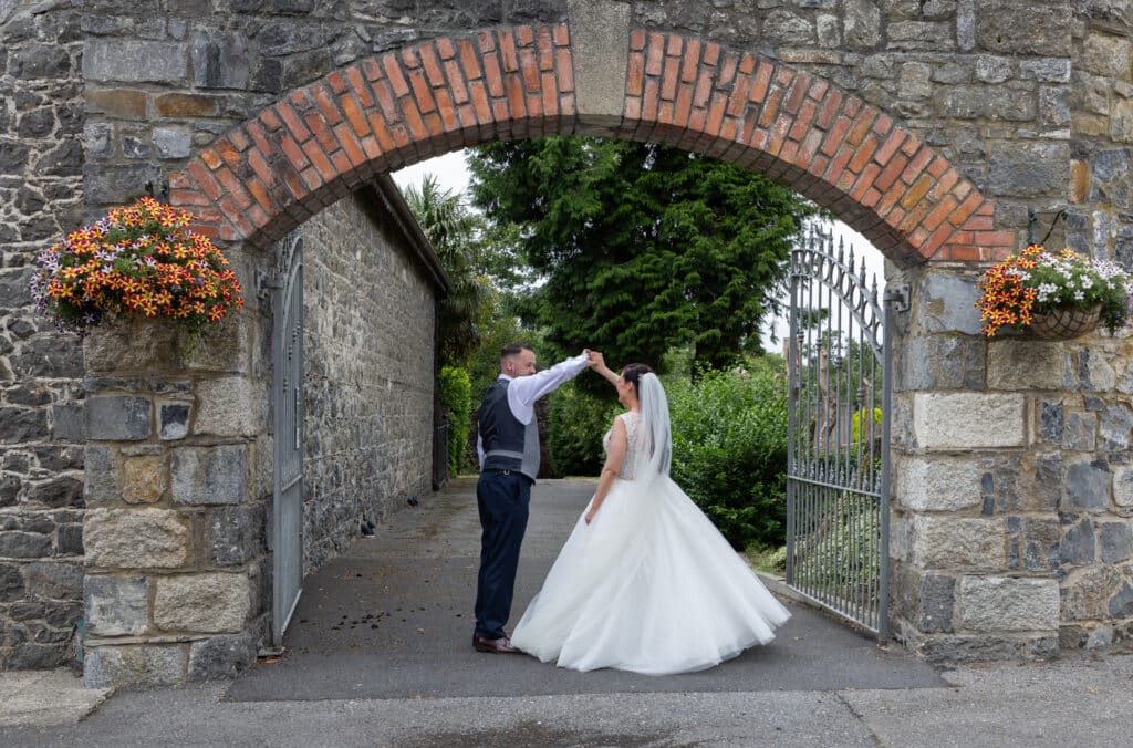 Amy & Kevin dancing at the gates of the Woodford Dolmen Hotel in Carlow